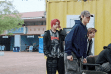 a man wearing a hoodie that says metallica stands next to another man