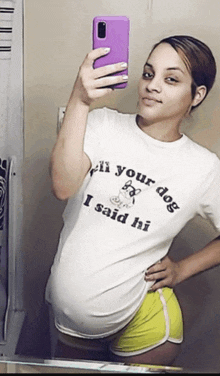 a woman is taking a selfie in front of a mirror wearing a shirt that says " your dog i said hi "