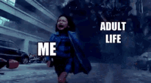a little girl in a cape is running in a parking lot with the words `` adult life me '' written on the bottom .