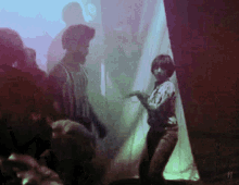 a woman dancing in a dark room with the number 11 on the bottom