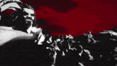 a black and white drawing of a group of people with a red sky in the background