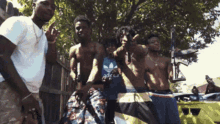 a group of young men posing for a picture with one wearing a blue shirt that says adidas