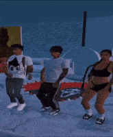 a man in a white shirt with a dollar sign on it is dancing with two other people