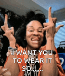a woman is making a rock sign with her hands and says i want you to wear it so i am to