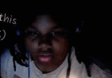 a person wearing headphones and a white shirt with the word this written on the bottom right