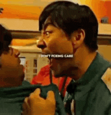 a man is making a funny face while talking to another man in a room .