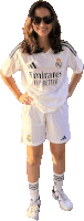a woman wearing a emirates fly better jersey