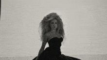 a woman with long hair blowing in the wind