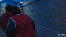 two people are running through a maze with a netflix logo on the bottom