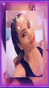 a woman in a black tank top is taking a selfie in a pink frame .