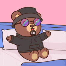 a teddy bear wearing a hat and glasses is laying on a bed