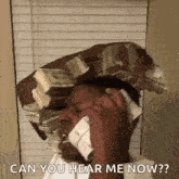 a man is talking on a cell phone while holding a stack of money on his head .