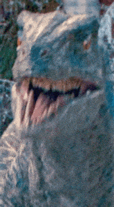 a close up of a dinosaur 's mouth with its tongue sticking out