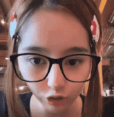 a girl wearing glasses has a hello kitty headband on her hair