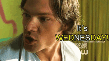 a close up of a man 's face with the words " it 's wednesday " on the bottom