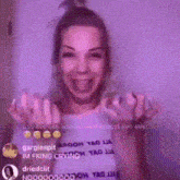 a woman in a purple shirt is making a funny face and giving the middle finger .
