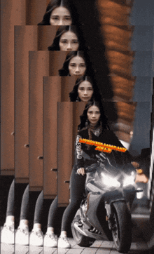 a woman standing next to a motorcycle has the word monster on her sleeve