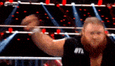 a man in a wrestling ring with his fist in the air ..