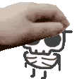 a hand is holding a drawing of a skull with sunglasses .