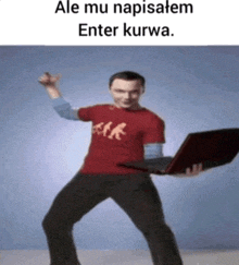 a man in a red shirt is holding a laptop and dancing