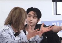 a man with a ring on his finger talks to a woman