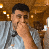 a man wearing a blue nyc brooklyn shirt
