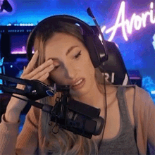 a woman wearing headphones is crying in front of a microphone .
