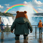 a bear is standing in front of a waterfall with a rainbow in the background