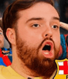 a man with a beard is making a funny face with his mouth open in a crowd .