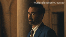 a man in a suit and tie is laughing with #abigbold beautifuljourney written above him