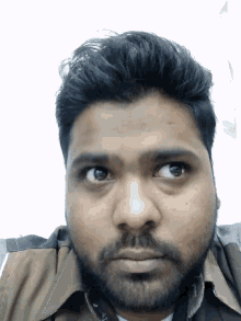 a close up of a man 's face with a beard
