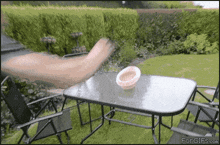 a picture of a table and chairs with forgifs.com written on the bottom