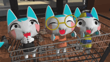 three cartoon cats wearing glasses and hats are standing in a cage