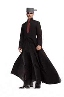 a man in a matrix costume is wearing a long black coat and a hat .