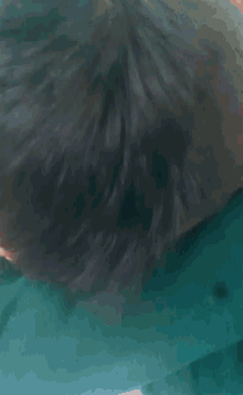 a close up of a man covering his mouth with his hand