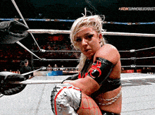 a woman in a wrestling ring with the aew summer blockbuster written on the bottom