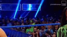 a crowd of people watching a wrestling match with the hashtag totaldivaseps on the bottom