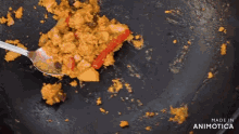 a spoon is being used to stir food in a pan with the words made in animatica below it