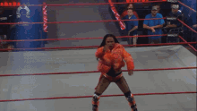 a woman in a wrestling ring with the word impact on the ring