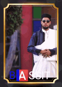 a man in a black hat and sunglasses is holding a baby in a frame with the letters b a and s on it
