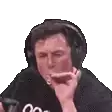 elon musk is wearing headphones and smoking a cigarette .