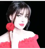 a woman in a red dress is holding a red flower in her hand