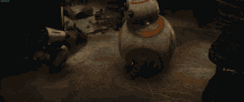 a bb-8 robot is sitting on a dirty floor
