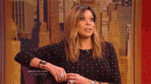 wendy williams is wearing a polka dot dress and a watch .