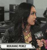 a woman named roxanne perez holds a microphone