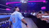a wrestler with the number 13 on his jersey