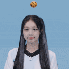 a girl with a cookie flying in the air on her head