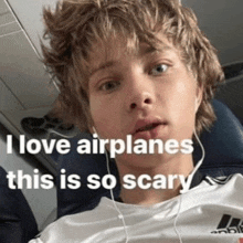 a young man is sitting on an airplane with a caption that says " i love airplanes "