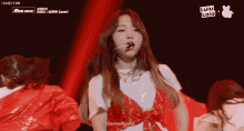 a girl in a red and white outfit is dancing on a stage