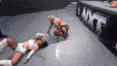 two women wrestling in front of a wwe banner